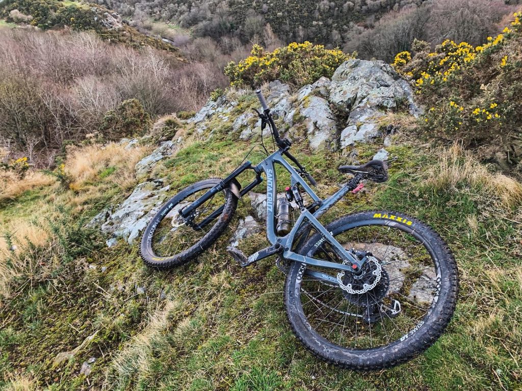 Mountain bike on a crag, with gorse bushes
